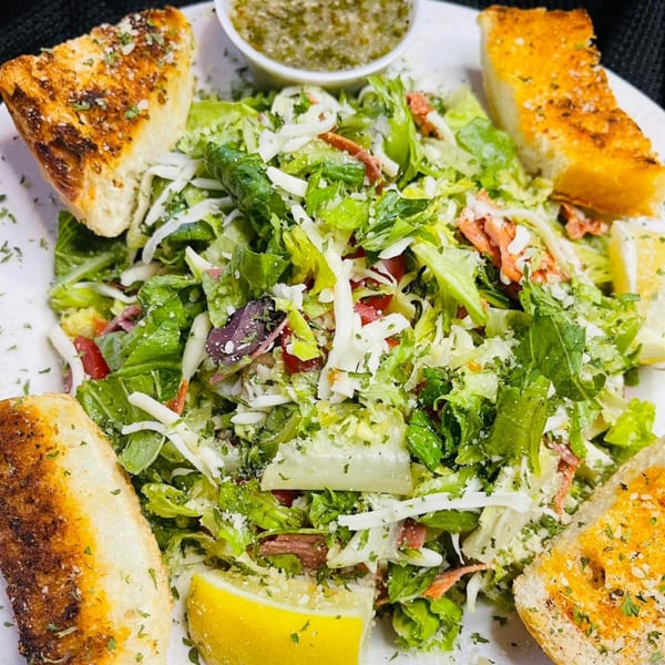 Figaretti's Italian salad with mixed greens, cheese, pepperoni, lemon, and garlic bread.